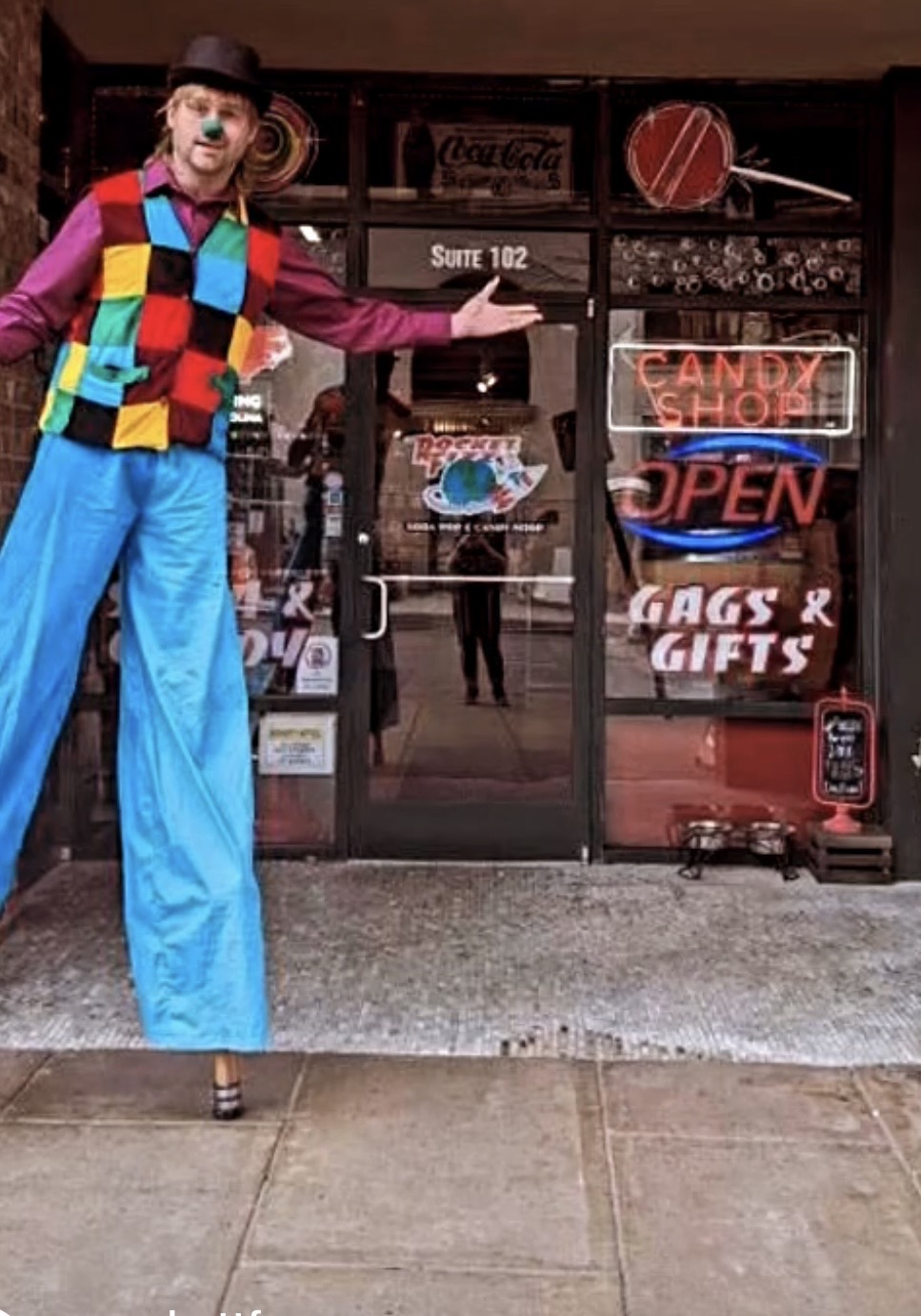 Josh welcoming guests with his circus performer personality