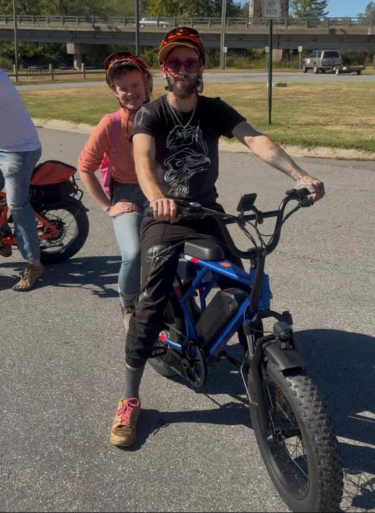 Couple riding together on one of our passenger bikes in Asheville